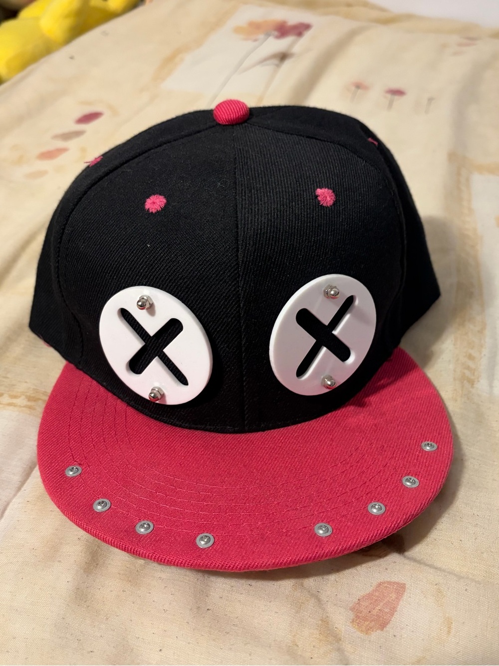 Black and pink hat with metal teeth
